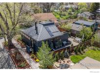Stunning aerial view of a modern home featuring a rooftop deck, lush landscaping, and inviting outdoor spaces at 1635 6Th St, Boulder, CO 80302