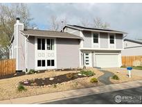 Charming two-story home featuring mature landscaping and a well-manicured front yard at 16807 E Napa Dr, Aurora, CO 80013