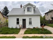 Charming two-story home featuring a white exterior, gray roof, and inviting front yard at 302 E Chester St, Lafayette, CO 80026