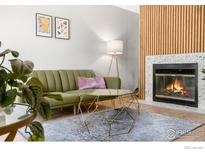 Bright living room features a cozy fireplace and modern furnishings at 540 S Forest St # 7-102, Denver, CO 80246