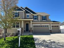 Two-story home featuring a three-car garage, manicured lawn and professionally designed landscape at 5478 Teton Dr, Longmont, CO 80504