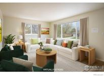 Bright living room featuring a white sectional sofa, round coffee table, and large windows at 740 Lotus Way, Broomfield, CO 80020