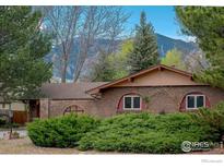 Charming single-story brick home featuring arched windows and beautiful landscaping at 285 Hopi Pl, Boulder, CO 80303