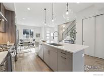 Bright open-concept kitchen features stainless steel appliances, pendant lighting, and a center island at 2909 32Nd St, Boulder, CO 80301
