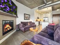 Comfortable living room features a fireplace, a TV, and modern decor at 3401 Arapahoe Ave # 402, Boulder, CO 80303