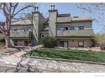 Multi-level home featuring a sidewalk, well-maintained lawn, and green siding at 3785 Birchwood Dr, Boulder, CO 80304