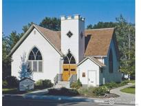 Charming white church with a tower, arched windows, and a well-maintained lawn at 641 Martin St, Longmont, CO 80501