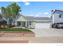 Charming single-Gathering home with a well-maintained lawn, two-car garage and inviting curb appeal at 803 W Lucerne Dr, Lafayette, CO 80026