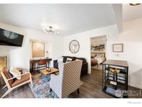 Inviting living room featuring hardwood floors, desk area, and stylish furnishings at 8050 Niwot Rd # 31, Niwot, CO 80503