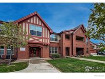 Beautiful brick building with charming architectural details and well-maintained landscaping at 1379 Charles Dr # 4, Longmont, CO 80503