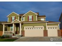 Inviting two-story home featuring a three-car garage, covered porch, and charming red shutters at 16341 Clayton St, Thornton, CO 80602