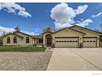 Spacious single-story home with a three-car garage, and landscaped front yard at 1720 Chaparro Cir, Berthoud, CO 80513