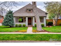 Charming home featuring a well-manicured lawn, mature landscaping, and inviting front porch at 2019 S Grant St, Denver, CO 80210