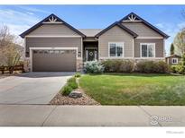 Beautiful single-Gathering home featuring a manicured lawn, stone accents, and a two-car garage at 3692 Deacon Dr, Mead, CO 80542