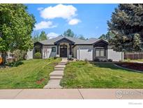 Charming one-story home features a well-manicured lawn and a classic white and black trim color scheme at 5302 Pinehurst Dr, Boulder, CO 80301