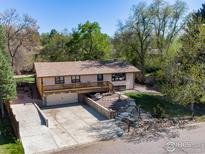 Charming ranch-style home with a large front yard, deck, and an attached garage at 7240 Glacier View Rd, Longmont, CO 80503