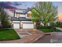 Beautiful two-story home with a two-car garage, solar panels, and landscaped front yard at 119 Ortega Ct, Erie, CO 80516