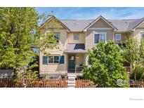 Charming two-story home with a well-manicured lawn, fenced yard, and inviting front porch at 1278 Hummingbird Cir # D, Longmont, CO 80501