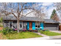 Charming single-story home with a well-manicured lawn, vibrant front door, and mature landscaping at 1419 Fillmore Pl, Louisville, CO 80027
