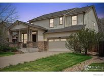 Charming two-story home with a welcoming front porch and two car garage at 1736 Trevor Ct, Longmont, CO 80501