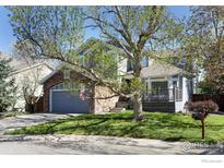 Charming two-story home featuring a stone-accented garage and inviting front porch at 1809 Keel Ct, Lafayette, CO 80026