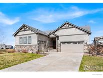 Charming single Gathering home featuring a manicured lawn, neutral color palette, and a two car garage at 1839 Pinion Wing Cir, Castle Rock, CO 80108