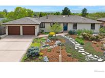 Charming ranch-style home with a well-manicured front yard and a two-car garage at 2721 Villanova Ct, Longmont, CO 80503