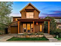 Charming two-story home featuring a covered porch, stone accents, and a well-manicured front yard at 3272 Big Horn St, Boulder, CO 80301