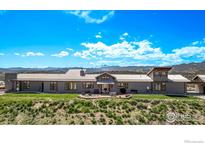 Stunning exterior showcasing a long, modern home with a patio and scenic mountain views at 399 Northview Rd, Berthoud, CO 80513