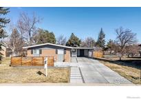 Charming single-story home featuring brick accents, a carport, and a well-maintained front yard at 4965 Ricara Dr, Boulder, CO 80303