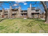 Charming townhomes with well-kept lawn, fences, and mature trees creating an inviting curb appeal at 5086 Buckingham Rd, Boulder, CO 80301