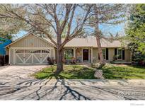 Charming single-story home featuring a well-maintained lawn, covered porch, and an attached two-car garage at 642 W Chestnut Ct, Louisville, CO 80027