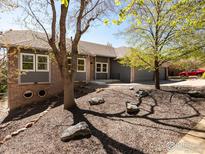 Charming home featuring a brick facade, complemented by well-maintained landscaping and a spacious three-car garage at 6668 Fairways Dr, Longmont, CO 80503