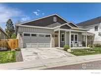 Charming single-Gathering home featuring a two-car garage and cozy front porch with seating at 741 Kohlor Dr, Lafayette, CO 80026