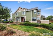 Inviting two-story townhome with a well-maintained lawn, lush greenery, and charming curb appeal at 15800 E 121St Ave # 4K, Brighton, CO 80603