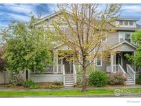 Charming two-story home with a welcoming front porch, beautiful lawn and landscaped front yard at 1675 Saratoga Dr, Lafayette, CO 80026