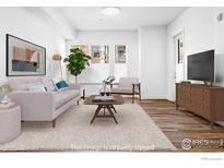 Bright living room with a plush rug, comfortable seating, and plenty of natural light at 1707 Walnut St # 101, Boulder, CO 80302