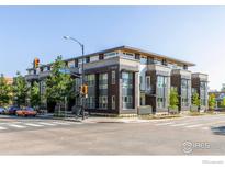 Modern condo building featuring a mixed facade of stone, wood, and large windows at 17 Walnut St at 1707 Walnut St # 104, Boulder, CO 80302