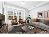 Bright living room with contemporary furniture, large windows, and stylish decor at 1707 Walnut St # 203, Boulder, CO 80302