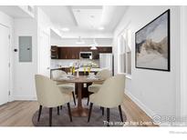 Well-lit dining area with modern pendant lighting adjacent to a kitchen featuring stainless steel appliances at 1707 Walnut St # 210, Boulder, CO 80302