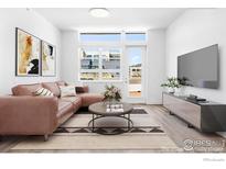 Bright living room with modern decor, hardwood floors, large windows, and comfortable seating area at 1707 Walnut St # 301, Boulder, CO 80302