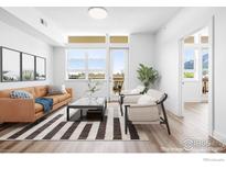 Bright living room with modern furnishings, hardwood floors, and large windows providing natural light at 1707 Walnut St # 305, Boulder, CO 80302