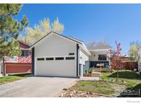 Charming home featuring a two-car garage, nice front yard, and appealing curb appeal at 1920 Donovan Dr, Longmont, CO 80501