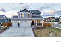 Beautiful two-story home with a two car garage, professional landscaping, and covered front porch at 2161 Gelbvieh St, Mead, CO 80542