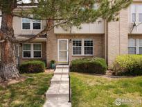 Charming brick townhouse with a well-maintained lawn and mature tree at 3098 W 107Th Pl # C, Westminster, CO 80031