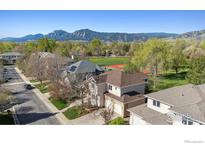 A beautiful home with a scenic mountain view in the background and mature trees surrounding the neighborhood at 4059 Nevis St, Boulder, CO 80301