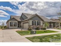 Charming exterior showcasing stone accents, a well-manicured lawn, and a welcoming facade at 4419 Maxwell Ave, Longmont, CO 80503