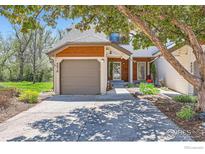 Charming home featuring an attached garage, front yard landscaping, and covered porch at 4619 Chestnut Ln, Boulder, CO 80301