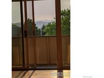 Balcony view through sliding glass door features scenic mountain views at 5124 Williams Fork Trl # 204, Boulder, CO 80301