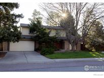 Charming two-story home with well-maintained lawn, mature trees and a two car garage at 11845 W 73Rd Dr, Arvada, CO 80005